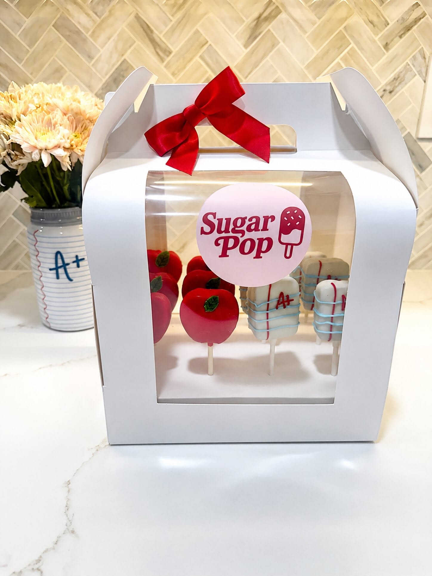 Sugar Pop gift box of custom apple and notebook cake pops